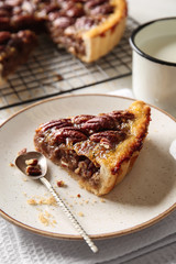 Plate with tasty pecan pie on table