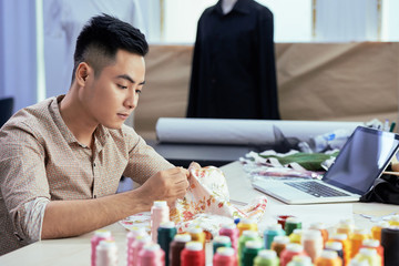 Fototapeta premium Young tailor at work
