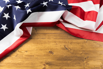 Flag of United States on a wooden table background.