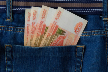 Banknotes Russian rubles in  pocket of jeans, background.