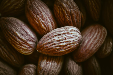 Raw almond nuts macro view background.