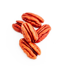 A group of raw pecan nuts, isolated on white background.