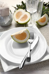 Beautiful table setting with citrus fruit
