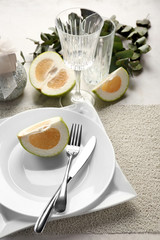 Beautiful table setting with citrus fruit