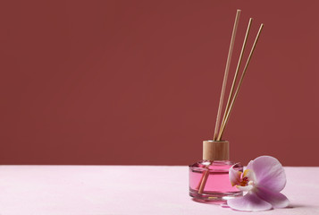 Reed diffuser and flower on table