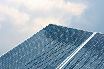 Solar cells are renewable energy with the sky background.