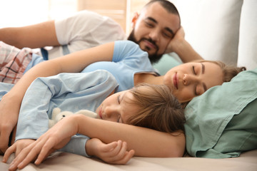 Obraz na płótnie Canvas Happy family sleeping in bed at home
