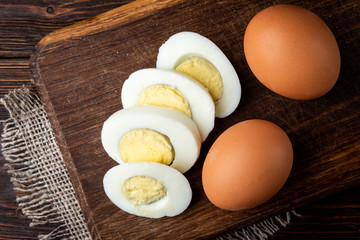 Boiled eggs on dark wooden background.