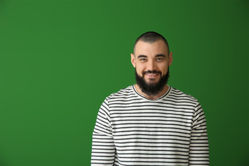 Happy bearded man on color background