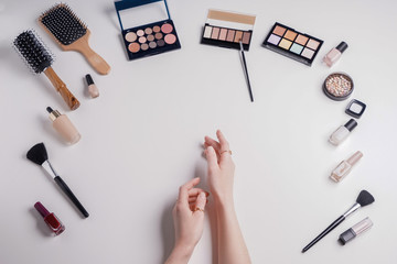 Beauty blogger with makeup cosmetics on white background