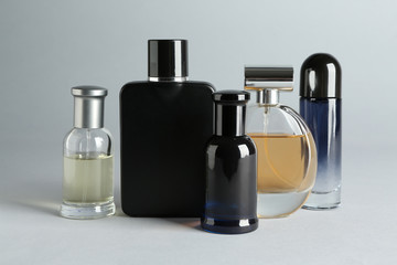 Bottles of perfume on light background