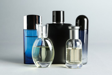 Bottles of perfume on light background