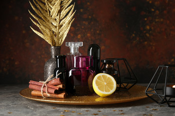 Bottles of perfume, spices and citrus fruit on tray