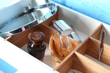 Bottles of perfume and mirror in wooden box