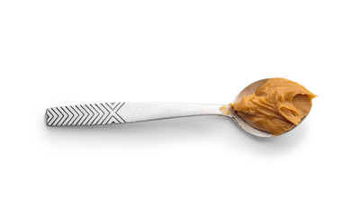 Spoon with tasty peanut butter on white background