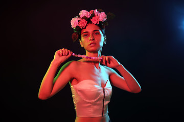 Toned portrait of beautiful young woman on dark background