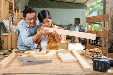 Father teaching son woodwork