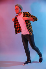 Toned portrait of handsome young man on color background