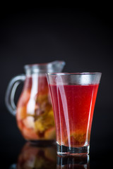 red fruit compote in a decanter with a glass