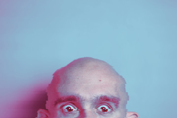 Neon glitch effect portrait of bald man. Retrowave concept.