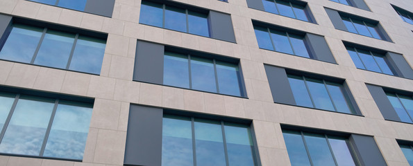 modern mirror windows building with sky and clouds reflection .