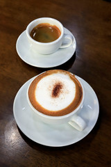 Hot coffee on wood background.