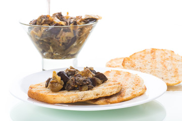 appetizer of cooked eggplant with vegetables on bread