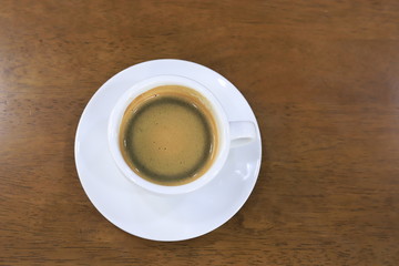 Hot coffee on wood background.