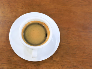 Hot coffee on wood background.