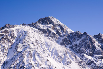 Fototapeta na wymiar Winter mountains with Sunny day. Kazbegi