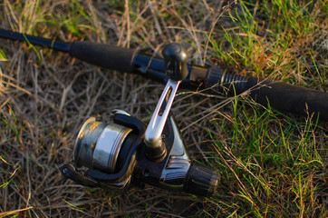 spinning with a coil lying on the green grass on a sunny spring day