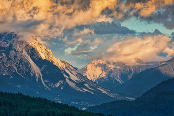 Mountain slopes in clouds at sunset, beautiful outdoor background