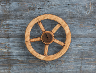 old cartwheel on a wooden background