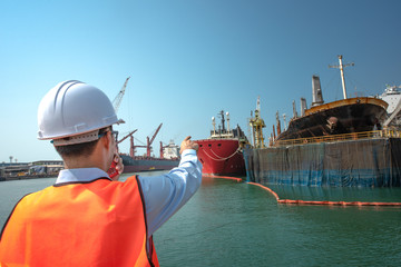 hand finger of harbor master port controller or engineering point to ship, to command the ship to...