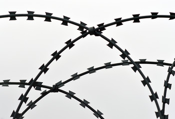 Razor blade barbed wire on sky background
