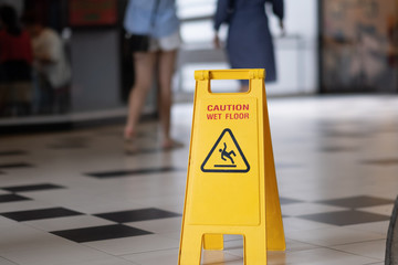 Sign showing warning of caution wet floor in airport.