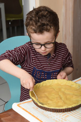 Fototapeta na wymiar child making a cake