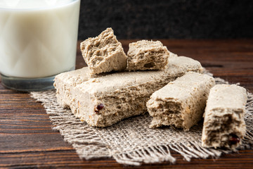 Sunflower halva with peanut on dark wooden background.