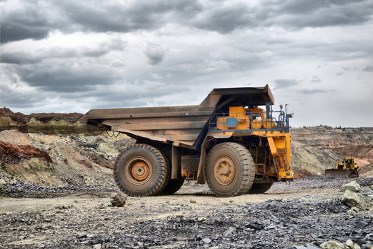 Large quarry dump truck. Loading the rock in the dumper. Loading coal into body work truck
