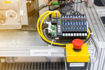 close up emergency stop switch of high performance automatic programmable logic controller manufacturing assembly and inspection process at production line