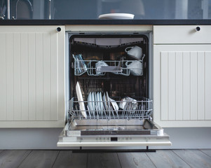 Modern kitchen. High angle view of utensils in dishwasher at kitchen - 249486043