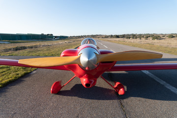 small red propeller plane