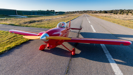 Fototapeta na wymiar small red propeller plane