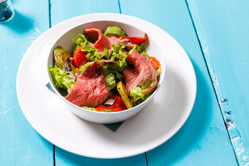 salad on a wooden blue table.