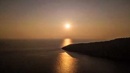 sunset over a beautiful island in Croatia, drone photo of a sunset over the ocean, 