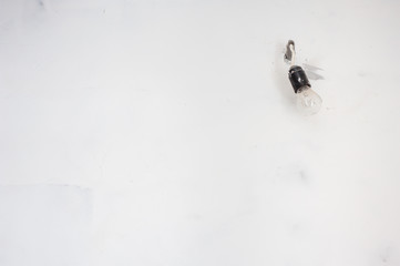 Lght bulb hanging on the electric wires.