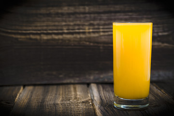 Fresh juice with orange on wooden table
