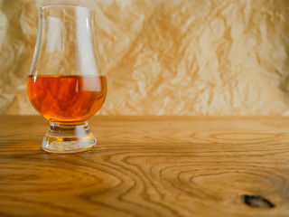 Irish Whiskey Glass on Wood and Paper Background Medium Shot