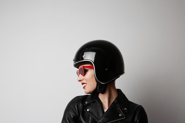 Fabulous woman with red lips in black leather jacket smiling looking at camera over white background. Fashion, glamour and transportation concept