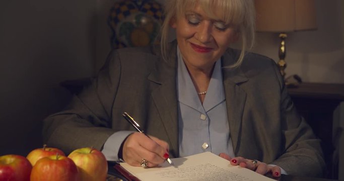 Woman writes letter with the fountain pen